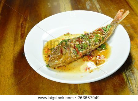 Crispy Fried Sharp Tooth Snapper Dressing With Sweet Chili Sauce On Plate