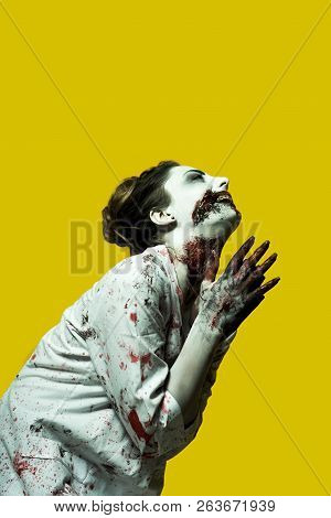 Scary Damaged Girl In Nurce Halloween Costume Looking Like Zombie On Yellow Background
