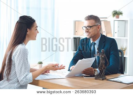 Happy Lawyer And Client Working With Papers And Smiling Each Other