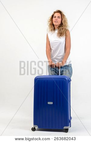 Beautiful Young Blonde Woman With Blue Plastic Suitcase On White Background