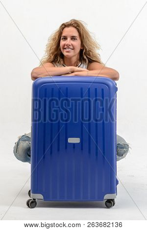 Beautiful Young Blonde Woman With Blue Plastic Suitcase On White Background
