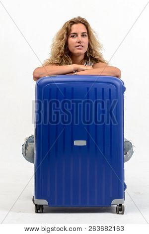 Beautiful Young Blonde Woman With Blue Plastic Suitcase On White Background