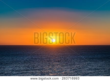 Idyllic Sunset Sea View With Beautiful Orange Colored Sun At Sky
