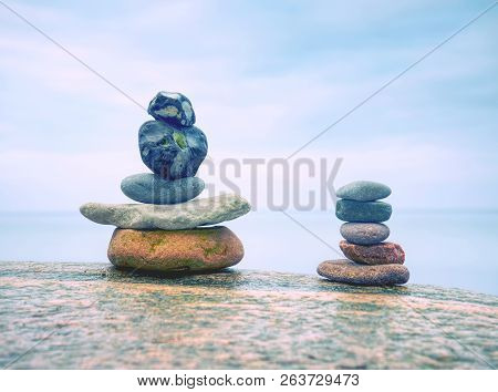 Stack Of Stones On The Sea Beach. Rounded Pebbles Stack In Peaceful Evening With Smooth Ocean Backgr