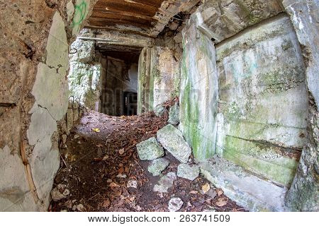 Demolished Bunker In Central Europe. Old Reinforced Concrete Fortifications Of The Pomeranian Embank