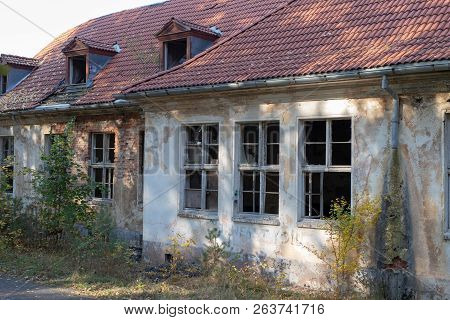 A Broken Window In An Old Abandoned Building. Broken Glass On The Window Site. Old Building.