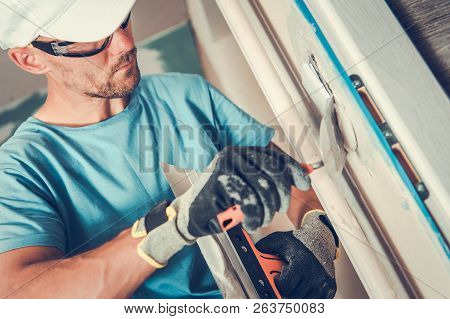 Apartment Self Remodeling. Finishing Wall Electrical Switch Points By Caucasian Men.