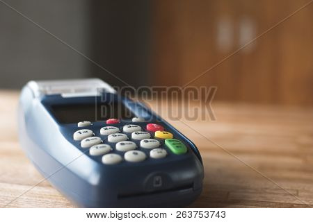 credit card machine on the wooden table with nobody