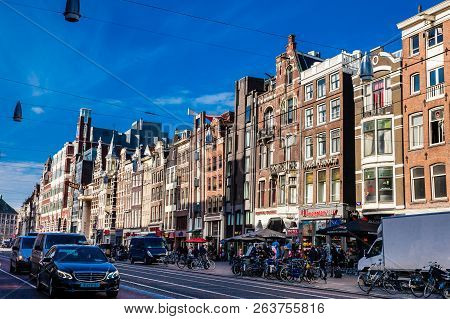 Amsterdam, Netherlands - March, 2018: The Damrak Avenue At The Old Central District In Amsterdam