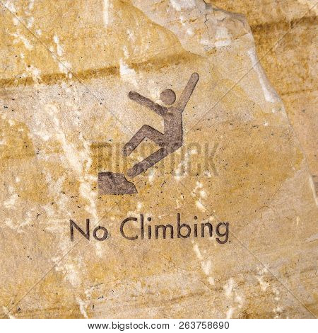 Brown Rock Engraved With No Climbing Sign