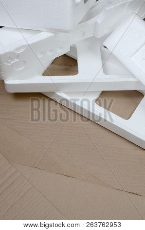 Background Image With Beige Cardboard Paper And Styrofoam Boxes Disgarded As Rubbish. The Concept Of