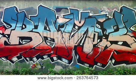 Full And Acomplished Graffiti Artwork. The Old Wall Decorated With Paint Stains In The Style Of Stre