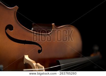 Close Up Of A Cello Set Against A Black Background