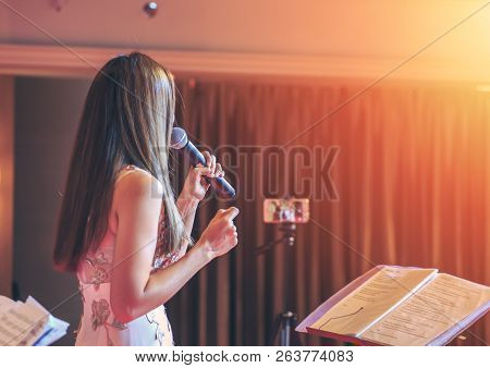 The Women Singing On Stage In Widding Room.