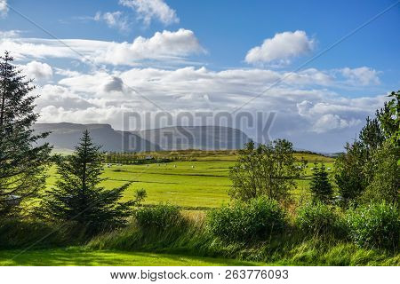 Farm Area Surrounded By Sunshine In A Valley With Mountains
