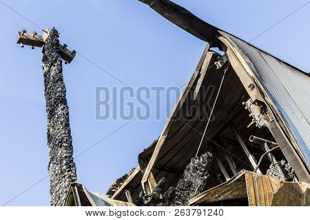 Damaged Roof Industry Supermarket After Arson Fire With Burn Debris Of Twisted Metal Structure After