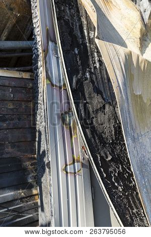 Close Up Damaged Industry Supermarket After Arson Fire With Burn Debris Of Twisted Metal Structure A