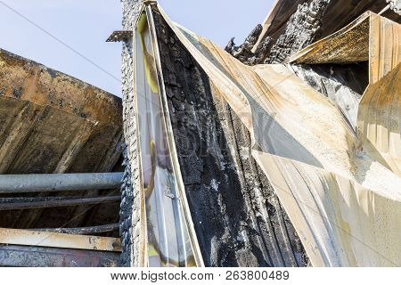 Damaged Industry Supermarket After Arson Fire With Burn Debris Of Twisted Metal Wood Structure After