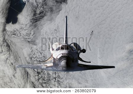 Space Ship Shuttle Flying Near Earth From The Hurricane And Massive Clouds In Atmosphere, Image Made