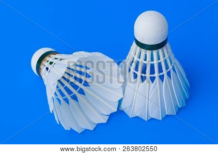 Badminton shuttlecocks on blue - sport background