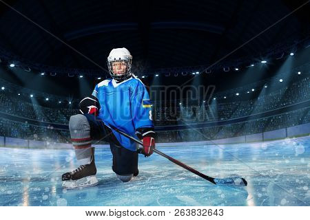 Hockey Player With Stick Standing On One Knee