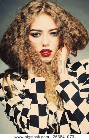 Portrait Of Attractive Radiant Looking Blond Young Woman With Fly-away Wavy Long Hair Wearing Black 