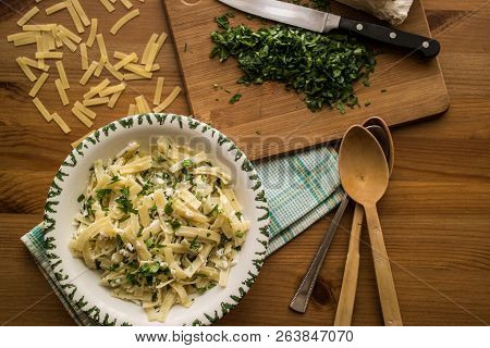 Turkish Noodle / Eriste With Cheese And Parsley On A Wooden Surface.