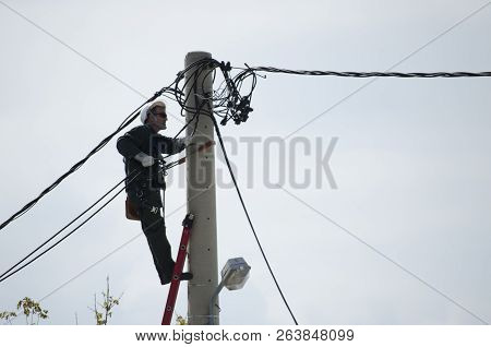 Athens, Acharnes, Stratopaido Kapota/ Greece - October 18 2018: Electrician Technician Worker Cut Ca
