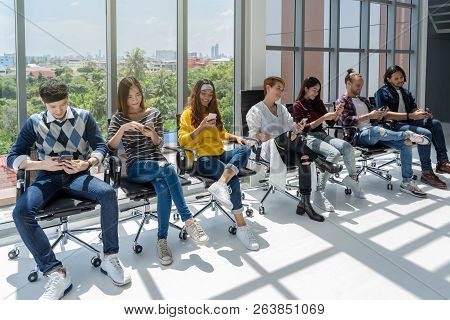 Group Of Asian And Multiethnic Business People With Casual Suit Using The Technology Device Theirsel