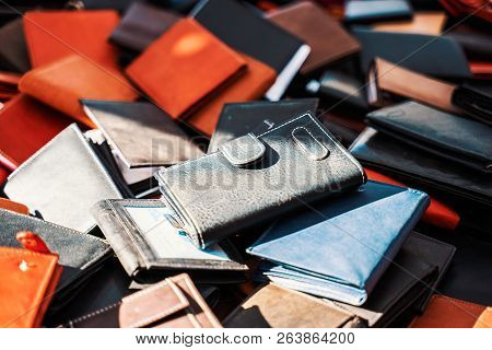 Many Differently Colored Purses Stacked On A Marketplace On A Sunny Day