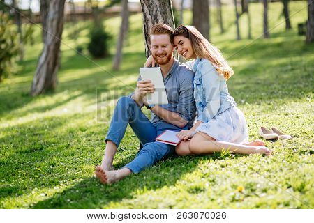 Lovely University Students Studying Outdoors In Park
