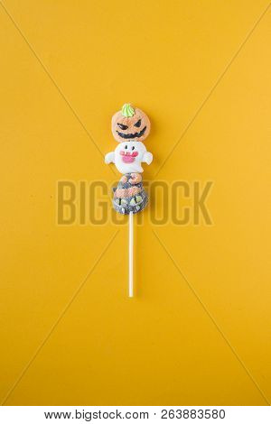 Halloween Candies Arranged In An Alternating Pattern On An Colored Background