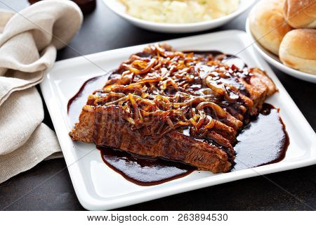 Sliced Brisket On A Plate With Caramelized Onions