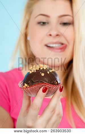 Diet, Sweets, Food Concept. Woman Holding Delicious Chocolate Cupcake With Peanut Frosting About To 