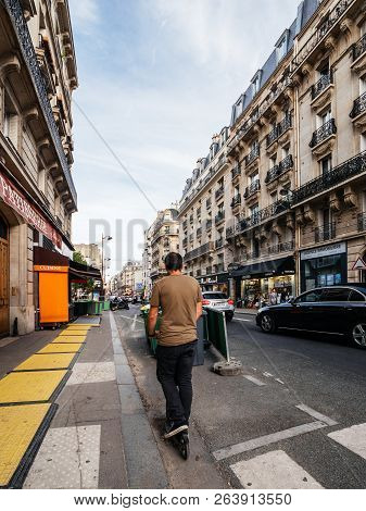 Paris, France - Oct 13, 2018: Man On Electric Scooter Commuting In Central Paris Vertical Photo