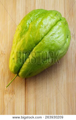 Fresh Green Chayote On Cutting Board Made Of Bamboo Wood, Viewed From Above
