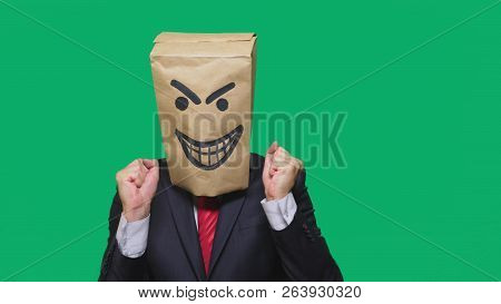 Concept Of Emotion, Gestures. A Man With A Package On His Head, With A Painted Smiley Angry, Sly, Gl