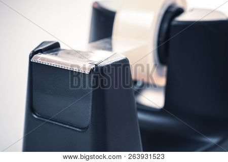 Macro Of A Black Sellotape Holder On A White Office Desk