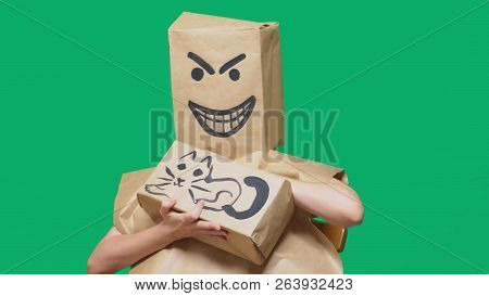 Concept Of Emotion, Gestures. A Man With A Package On His Head, With A Painted Smiley Angry, Sly, Gl