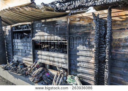 Close Up Damaged Industry Supermarket Metallic Facade After Arson Fire With Burn Debris Of Plastic B