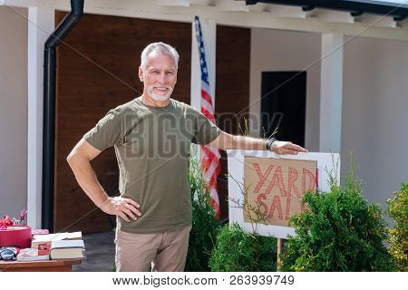 Bearded Beaming Man Feeling Satisfied After Organizing Amazing Yard Sale