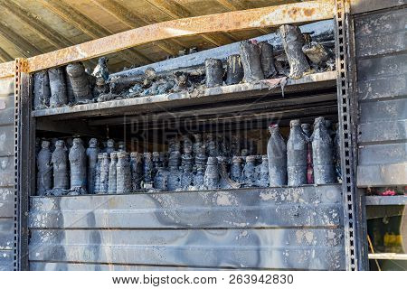Close Up Damaged Industry Supermarket Metallic Facade After Arson Fire With Burn Debris Of Beer Bott