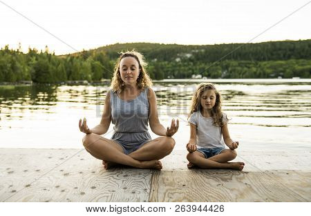 Happy Family Mother And Child Daughter Doing Yoga