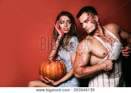 Halloween Student Party In Blood. Couple Of Muscular Man And Bloody Young Woman With Wounds And Red 