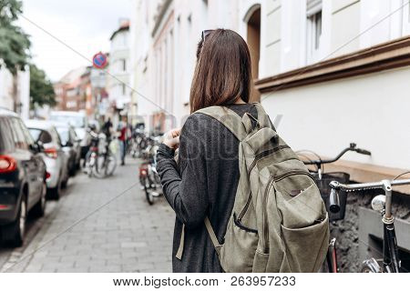 Tourist With A Backpack Is Looking For Booked Online Accommodation In An Unfamiliar City. Or A Stude
