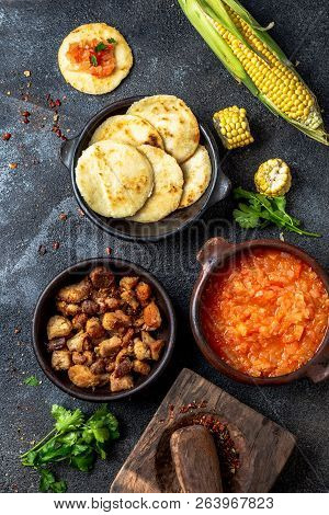 Colombian Traditional Food. Chicharron, Maize Arepas With Tomato And Onion Sauce. Top View