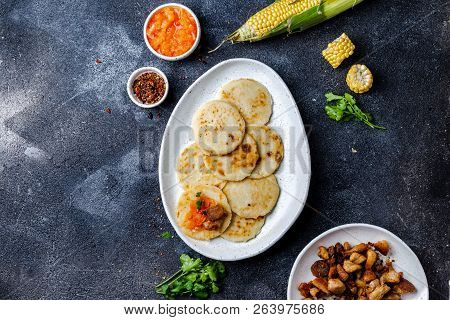 Colombian Food. Maize Arepas And Fried Pork Chicharron Ans Colombian Tomato Sauce. Top View. Black B
