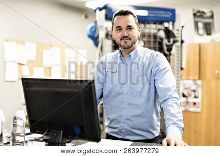 Merchandiser Checking Products Availibility For Car Repair