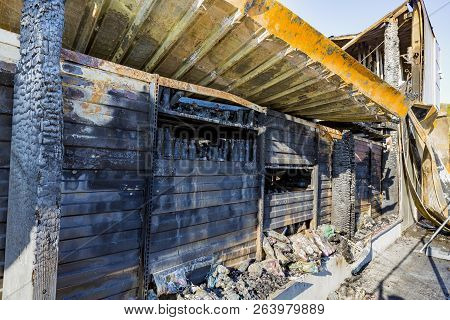 Damaged Industry Supermarket After Arson Fire With Burn Debris Of Twisted Metal Wood Structure After