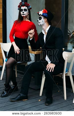 A Couple, Wearing Skull Make-up For. All Souls Day. Boy And Girl Sugar Skull Makeup.painted For Hall
